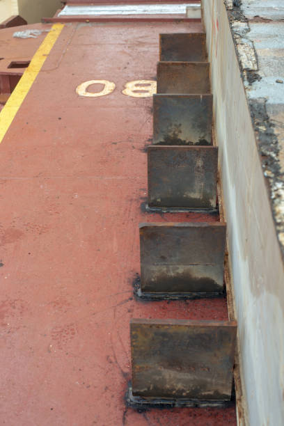 istock Safe cargo lashing onboard of ship deck with cargo steel stoppers. 1354000728