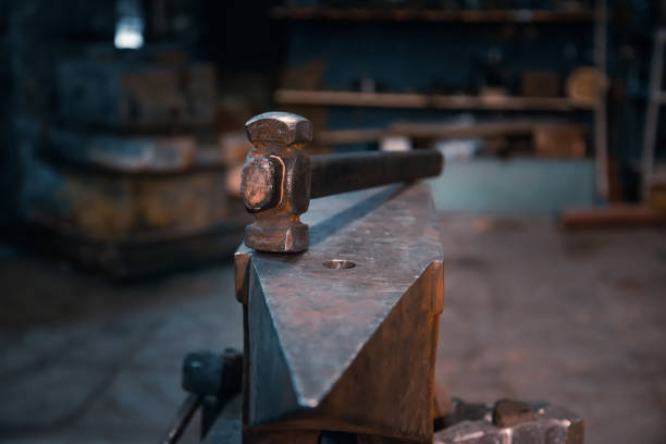 istock Hammer on an anvil in a forge, general view. 1354002560