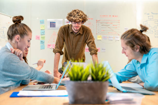 istock Team of young business people working and developing plans in the office. 1354009569