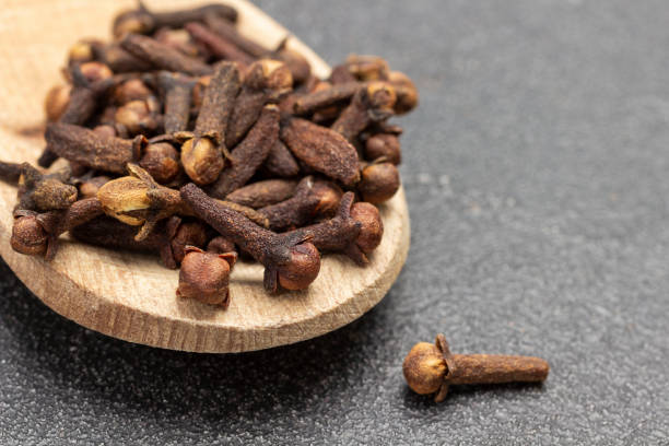 istock Dry cloves in wooden spoon. 1354012906