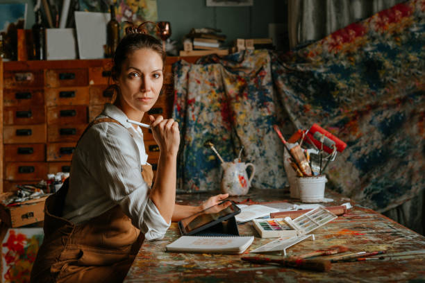 istock Professional female artist working at her studio 1354014414