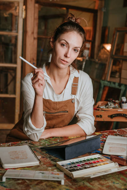 istock Seroius young designer holding stylus pen working on digital tablet 1354015271