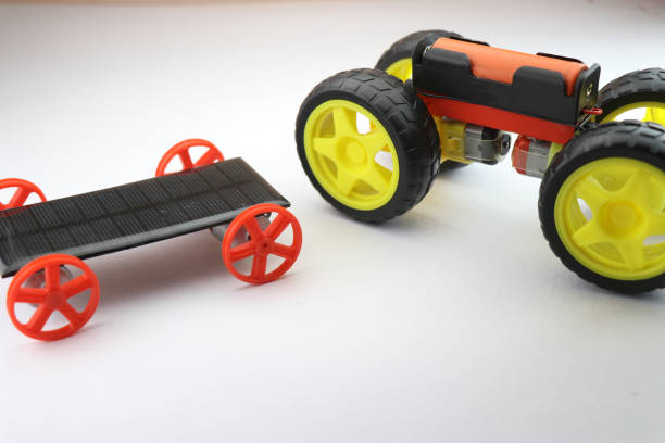 istock Mini electric car and small solar car working models side to side comparison isolated on white, useful science projects 1354020356