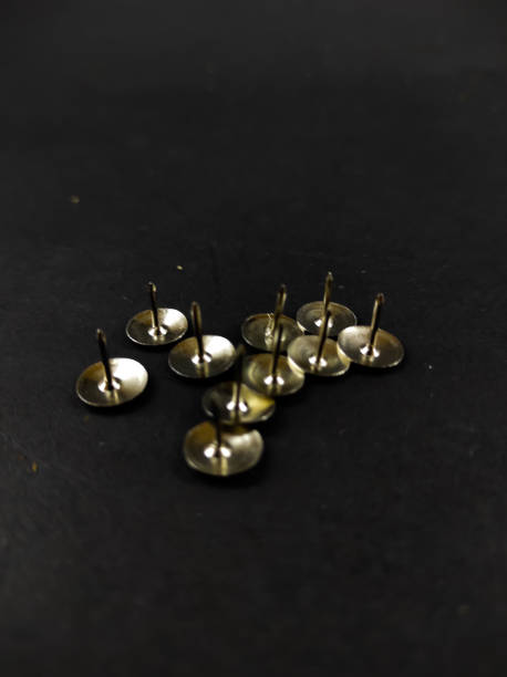 istock Tacks on black - stock photo 1354020453
