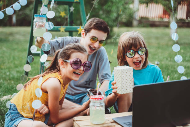 istock Happy children celebrating birthday virtual at backyard. 1354021242