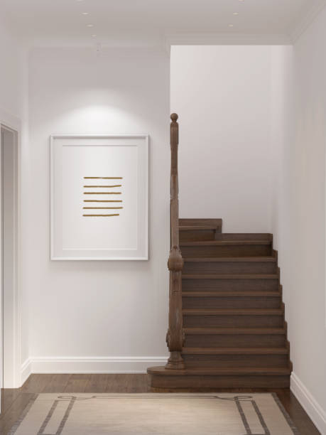 istock A bright hall in a modern classic style with a vertical poster on a white wall next to a classic wooden staircase, a beige carpet on a wooden floor, spotlights embedded in the ceiling. 1354021774
