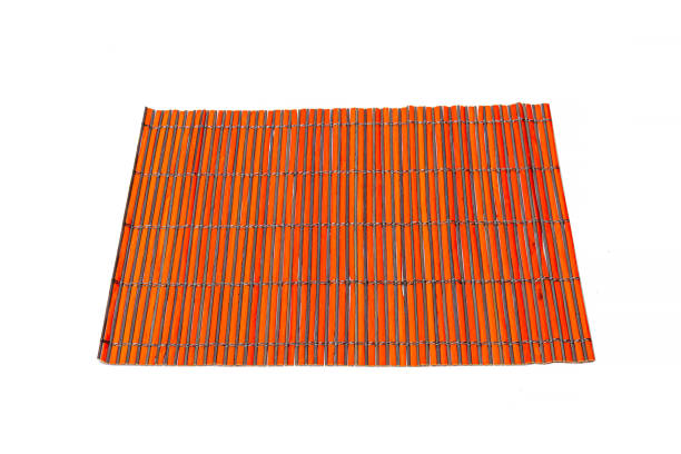 istock Bamboo rug for making sushi on a white isolated background. Kitchenware. 1354022417