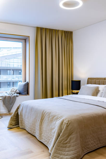 istock Cozy bedroom interior with wide double bed 1354024204