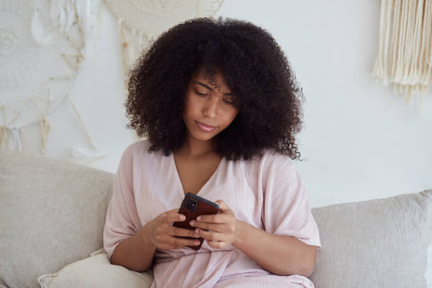 istock Thoughtful young mixed raced woman using smartphone enjoying chatting with boyfriend 1354026194