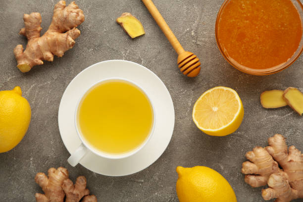 istock Ginger tea with lemon and honey on grey concrete background. 1354026243