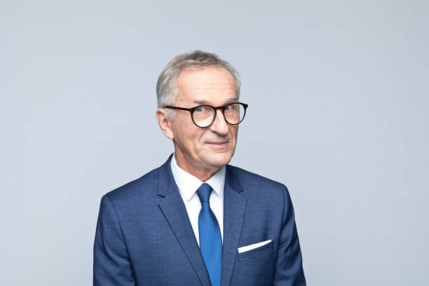 istock Headshot of friendly senior businessman 1354026268