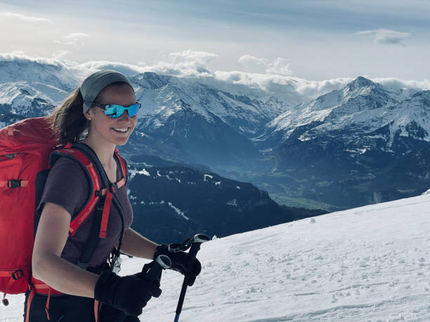 istock Female backcountry skier climbs snow slope 1354027280