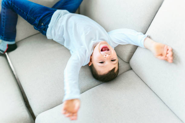 istock Little crazy boy on living room look like hyperactive 1354027292