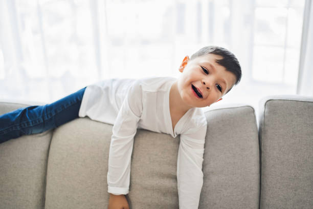 istock Little crazy boy on living room look like hyperactive 1354027498