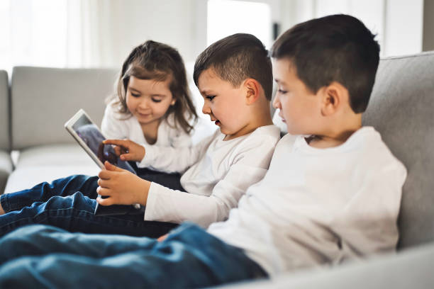 istock Childs relaxing with their tablets on a comfortable sofa at home 1354027614