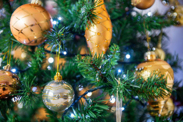 istock Close up of Christmas tree decorations with illuminated lights. 1354028507