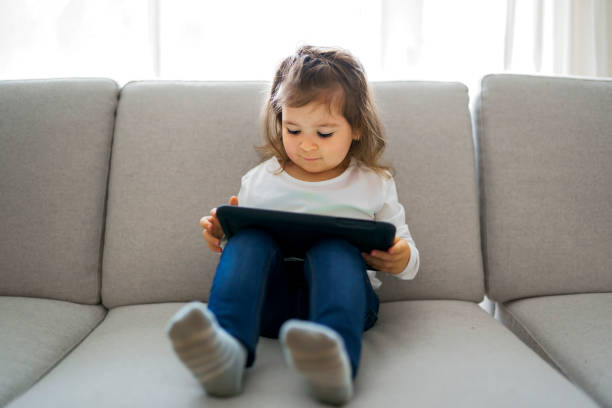 istock little student girl with tablet pc at home 1354028510