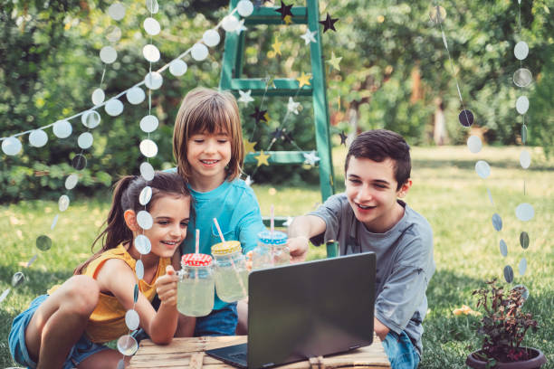 istock Happy children celebrating birthday virtual at backyard. 1354030979