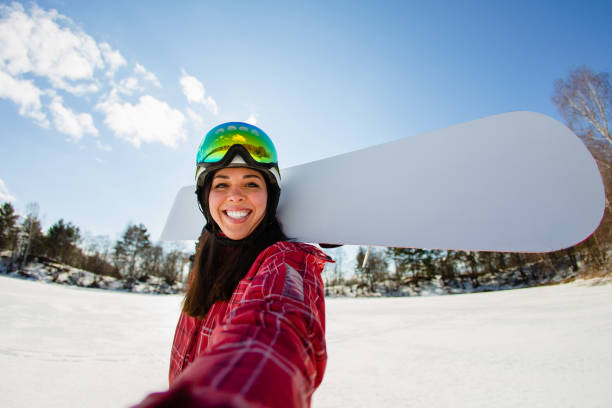 beautiful young woman with the snowboard making selfie - skiing winter women snow imagens e fotografias de stock