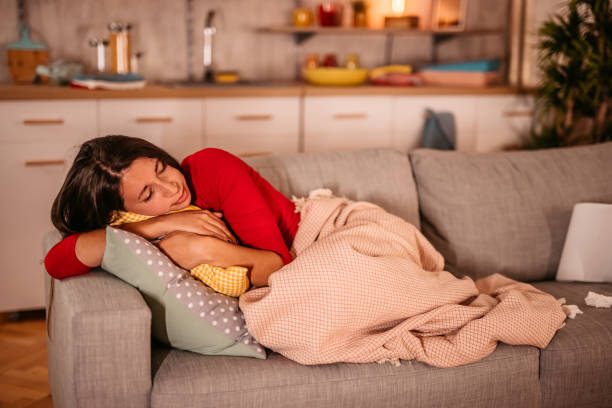 istock Tearful or sick woman fall a sleep on couch 1354031370