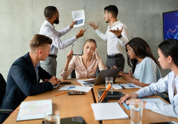 Workplace Conflicts. Stressed Group Of Business People Having Disagreements During Corporate Meeting stock photo