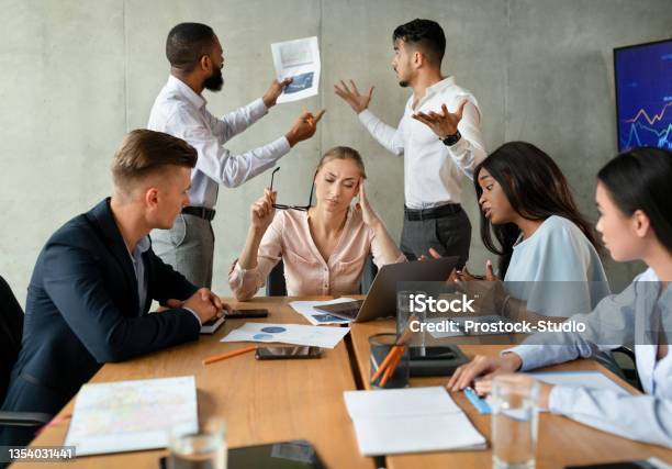 Workplace Conflicts Stressed Group Of Business People Having Disagreements During Corporate Meeting Stock Photo - Download Image Now