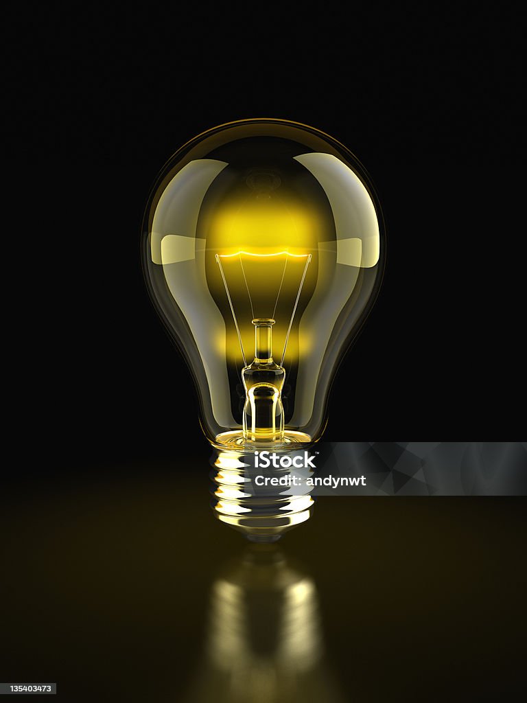 Glowing Light Bulb Glowing light bulb on dark background. Clipping path included. Black Background Stock Photo