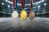 istock real Gold, silver and bronze medals in the large, illuminated winter ice stadium 1354034891