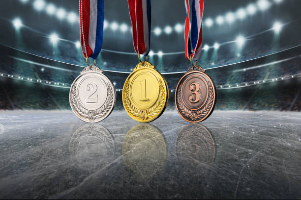 real gold, silver and bronze medals in the large, illuminated winter ice stadium - bronze medal medal bronze winning imagens e fotografias de stock