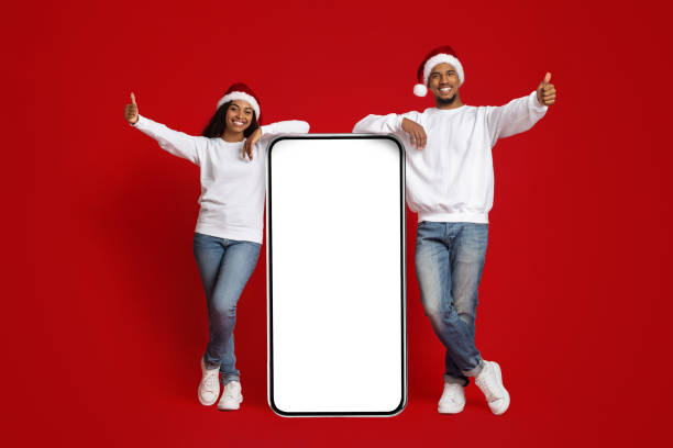 istock Happy beautiful black couple with huge cellphone, mockup 1354035418
