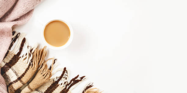 istock Autumn composition. Cup of coffee, plaid, sweaters on white background. Flat lay, top view, copy space 1354035544