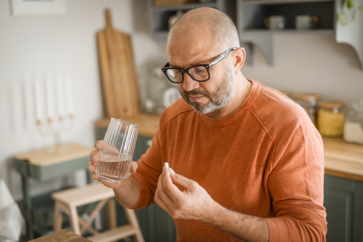 Mature adult man in cozy interior of home kitchen