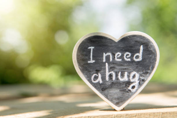 istock I need a hug hand drawing phrase on a heart, Sharing a Hug concept 1354039713
