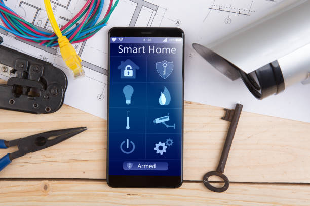 Home security concept smartphone with smart home app and surveillance cctv camera on the desk stock photo