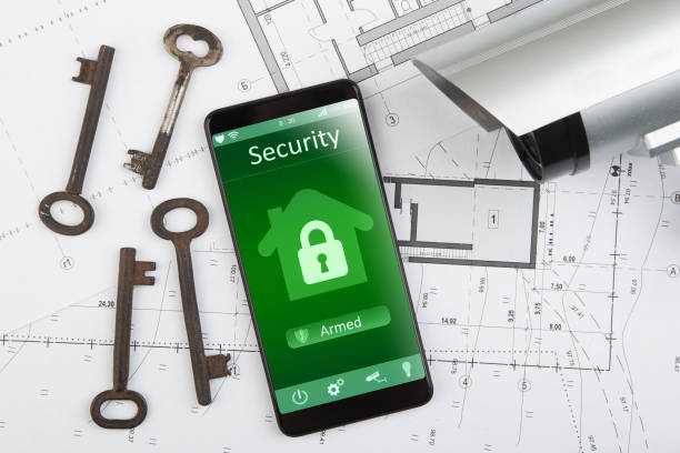 istock Home security concept smartphone with smart home app and surveillance cctv camera on the desk 1354041926