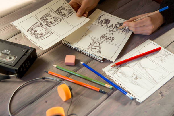 istock Artist drawing an anime comic book in a studio. Wooden desk, natural light 1354042507