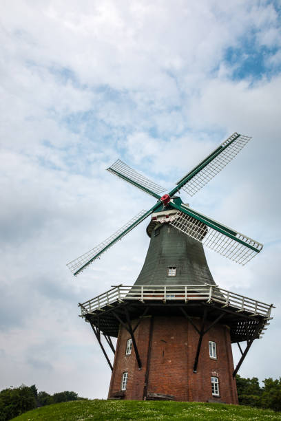 istock Big windmill nearby the canal and a cloudy sky 1354042936