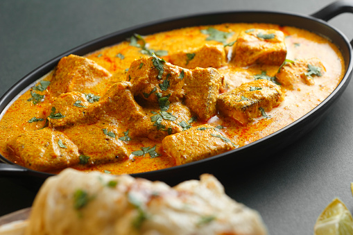 Indian Food Curd Paneer Masala with Butter Nan. Paneer is an Indian Dish of Marinated Paneer Cheese Served in Spiced Gravy