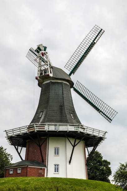 istock Big windmill nearby the canal and a cloudy sky 1354042959