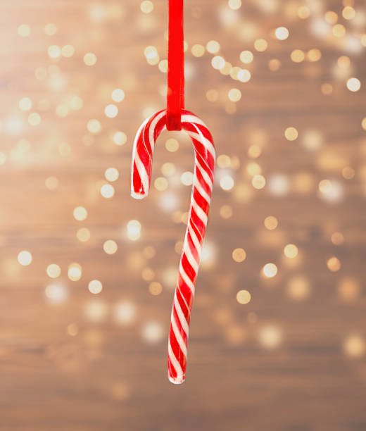 istock Christmas postcard. Lollipop close-up with a garland. 1354044462