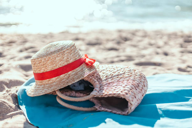 istock Straw hat, bag, sunglasses and bedspread on a tropical beach. Summer vacation 1354044565