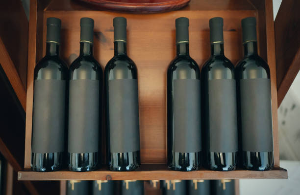istock Red wine bottles stacked on wooden rack. 1354045498