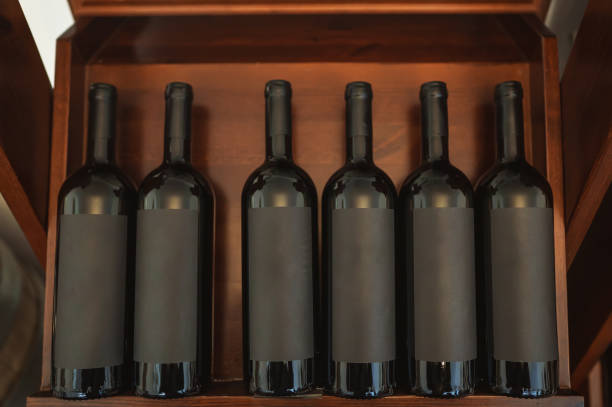 istock Red wine bottles stacked on wooden rack. 1354045499
