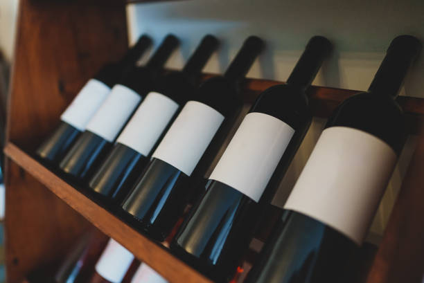 istock Red wine bottles stacked on wooden rack. 1354045500