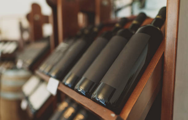 istock Red wine bottles stacked on wooden rack. 1354045512