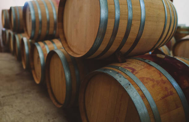 istock Wine barrels stacked in the cellar. 1354045522
