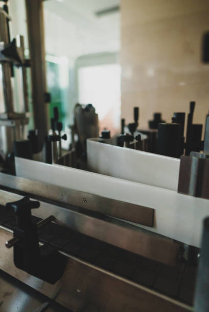 istock Automatic line for bottle labeling at wine factory. 1354045545