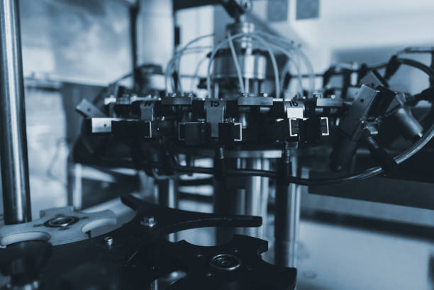 istock Automatic monoblock wine filling machine at wine factory. 1354045560