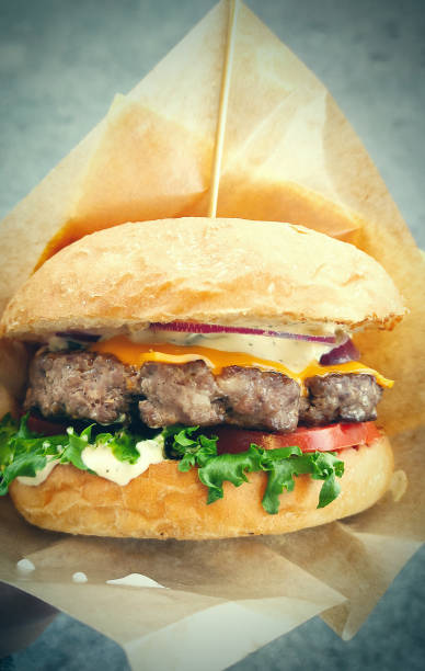 istock Burger with meat and melted cheese in fresh bun. 1354045565