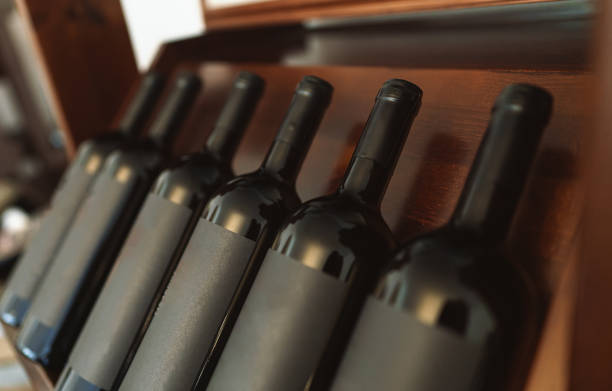 istock Red wine bottles stacked on wooden rack. 1354045628